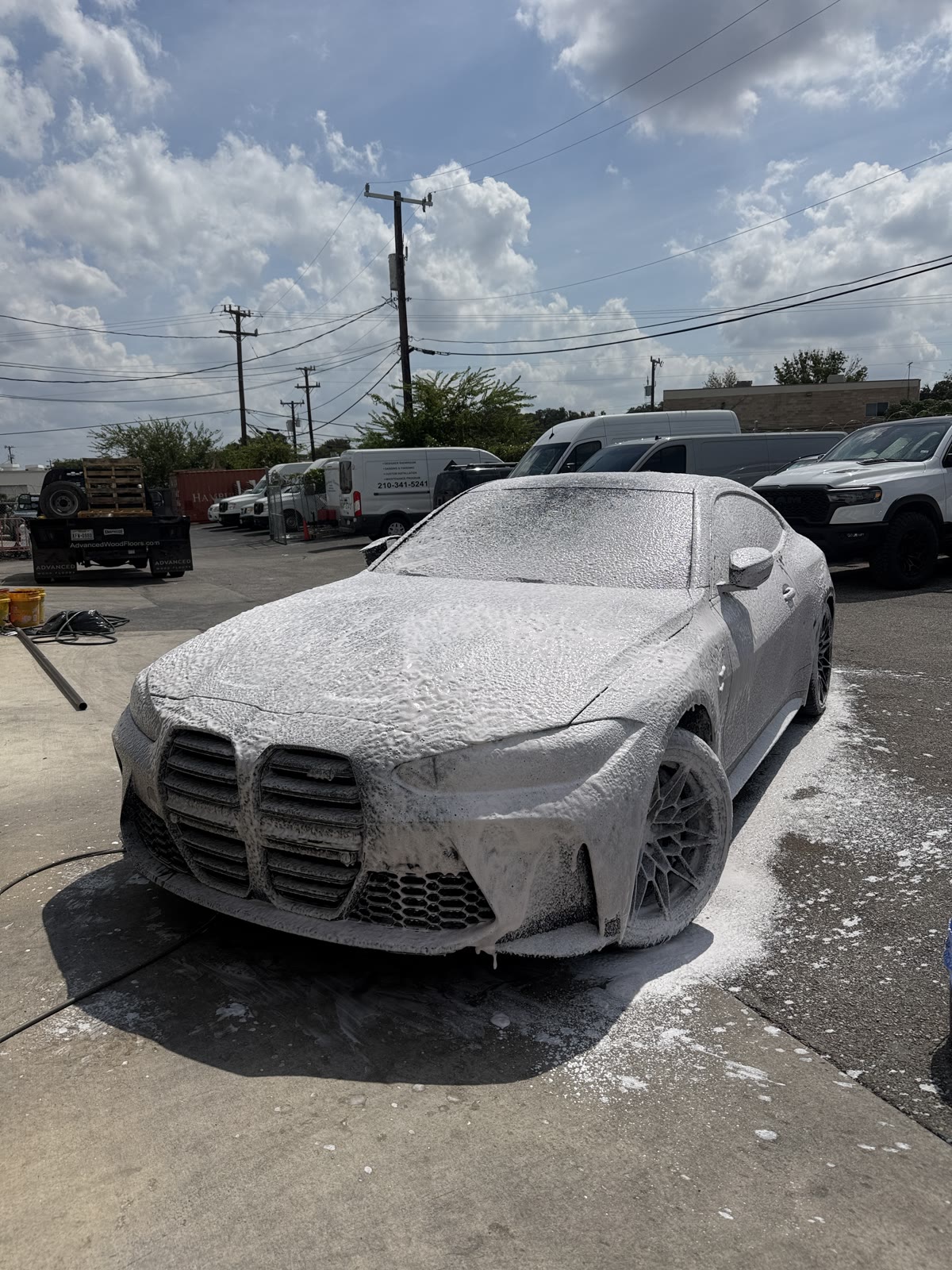 BMW covered in wash foam during an exterior detail
